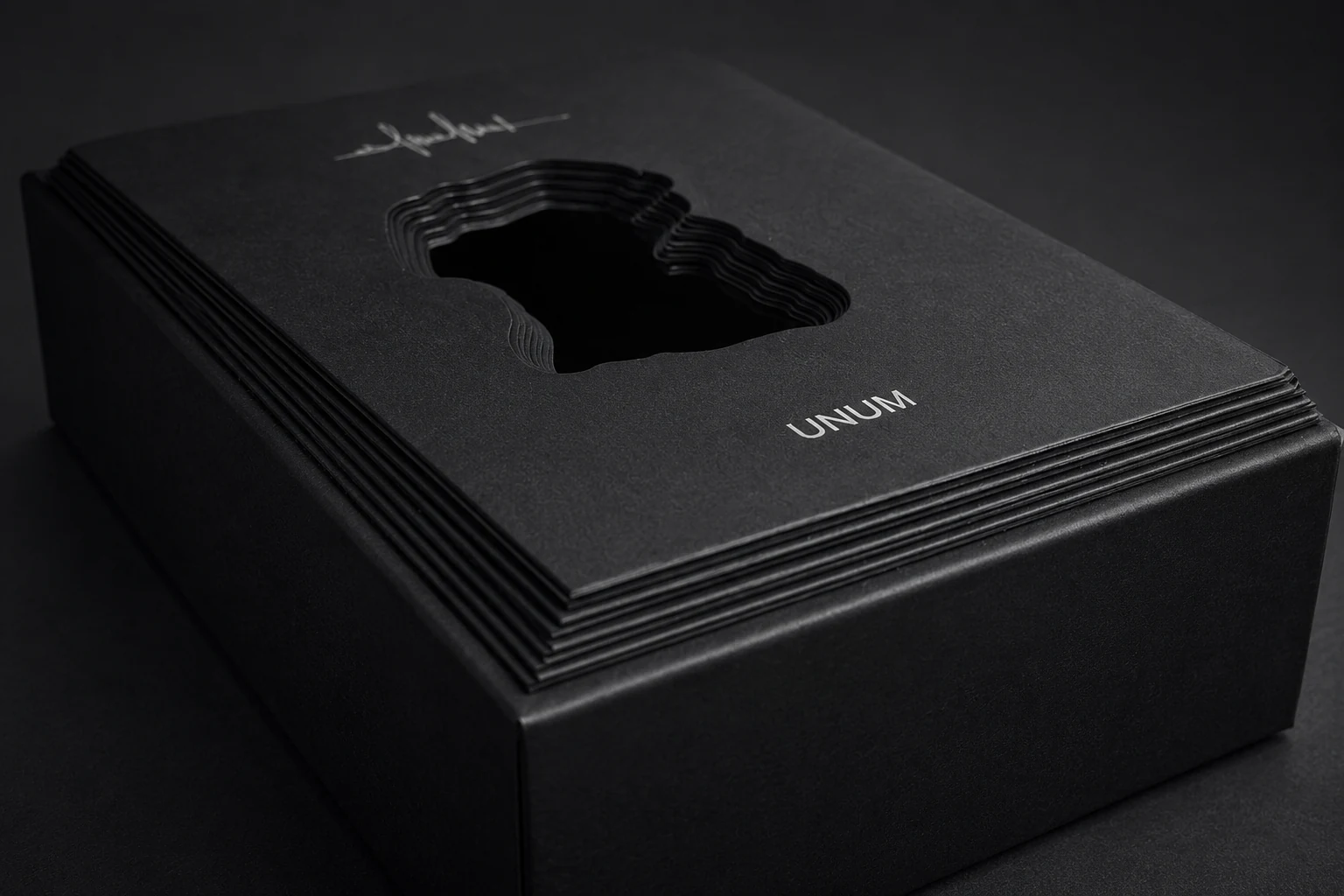 UNUM black rigid box with layered sculpted die-cut window
